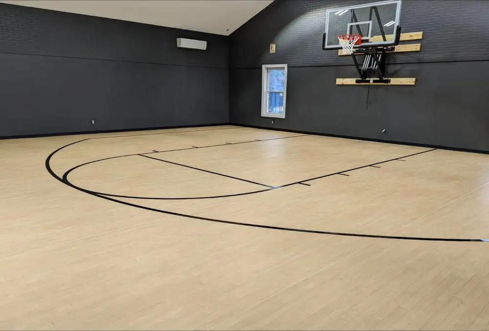 Gymnasium with dark gray walls and athletic flooring